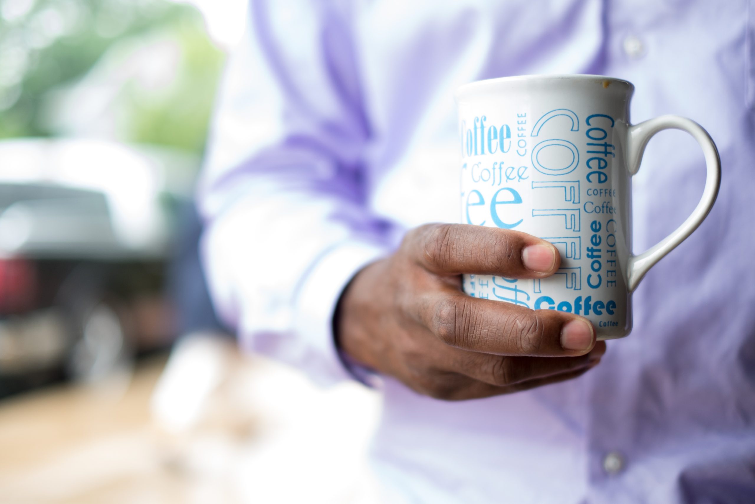 mug with coffee written multiple times in blue