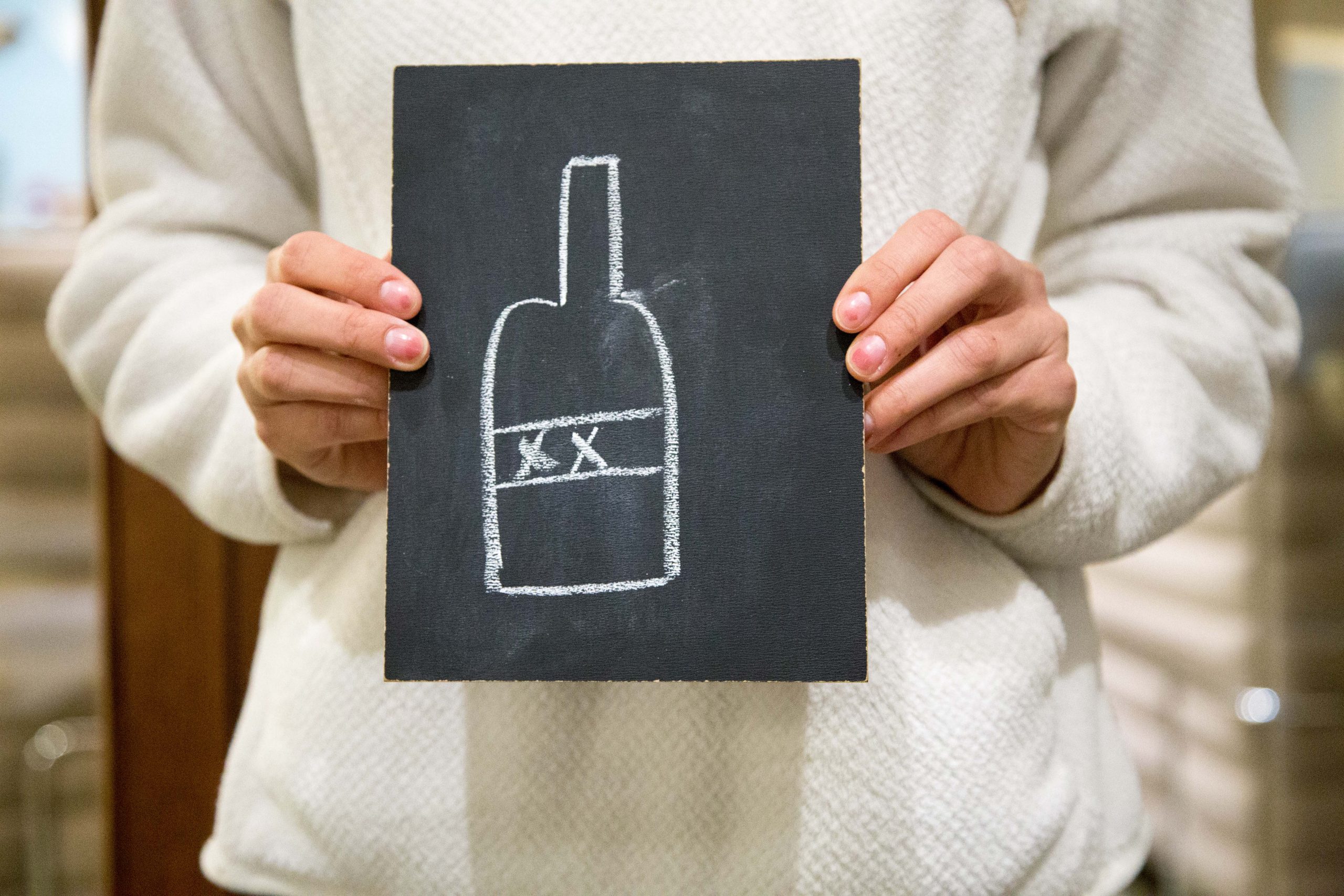 Chalkboard with bottle with XX label drawn in chalk