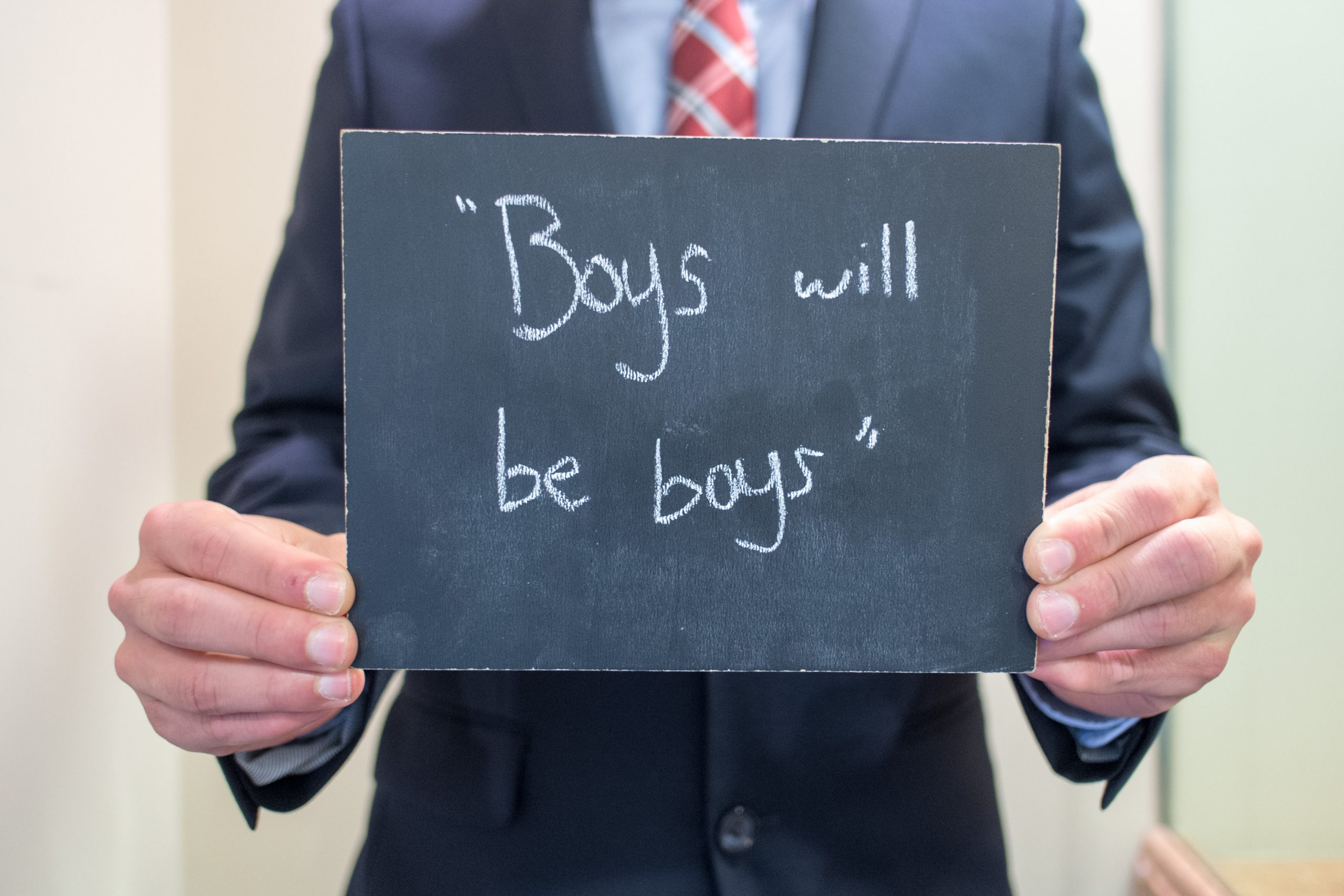 Chalkboard stating "Boys will be boys" written in chalk
