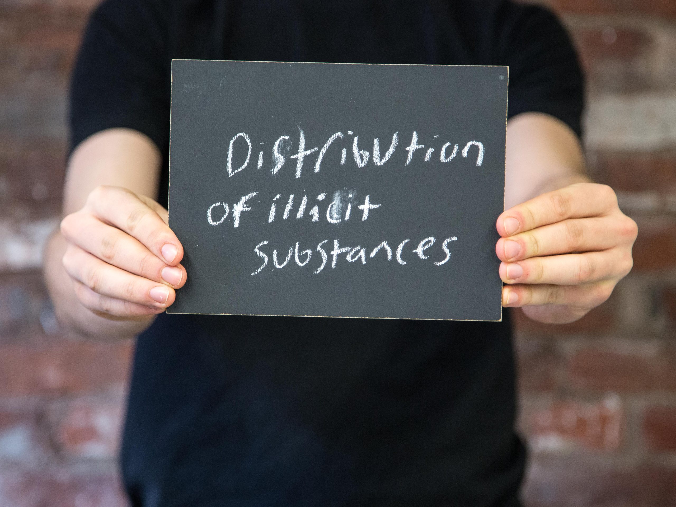 Chalkboard stating Distribution of illicit substances written in chalk