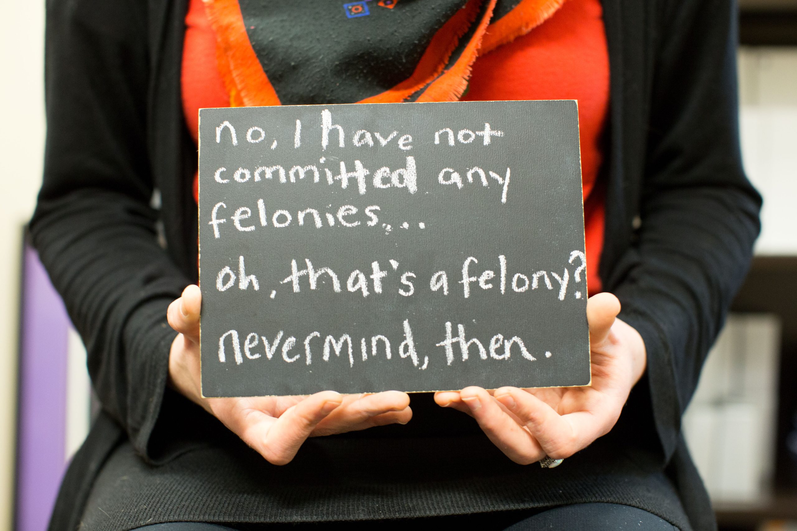 Chalkboard stating No, I have not committed any felonies . . . oh, that's a felony? never mind, then written in chalk
