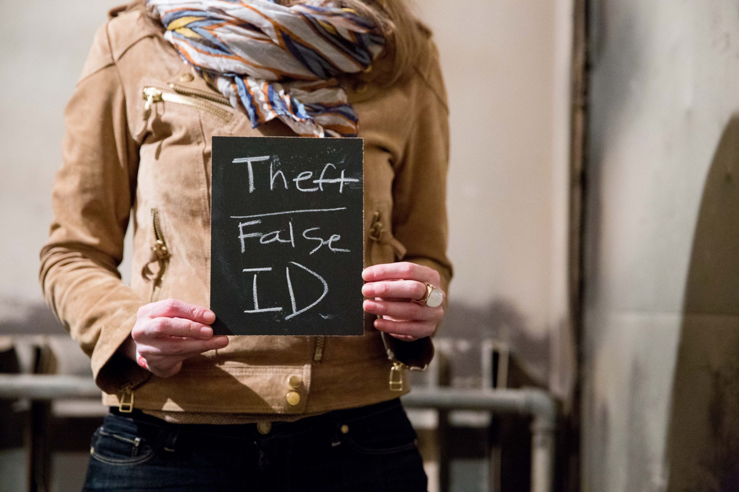 Chalkboard stating Theft False ID written in chalk