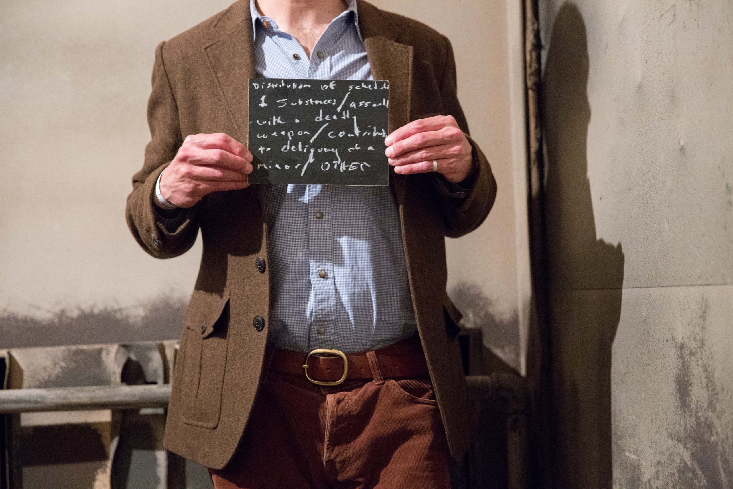 Chalkboard stating Distribution of Schedule 1 substances/assault with a deadly weapon/constributing to delinquency of a minor/other written in chalk