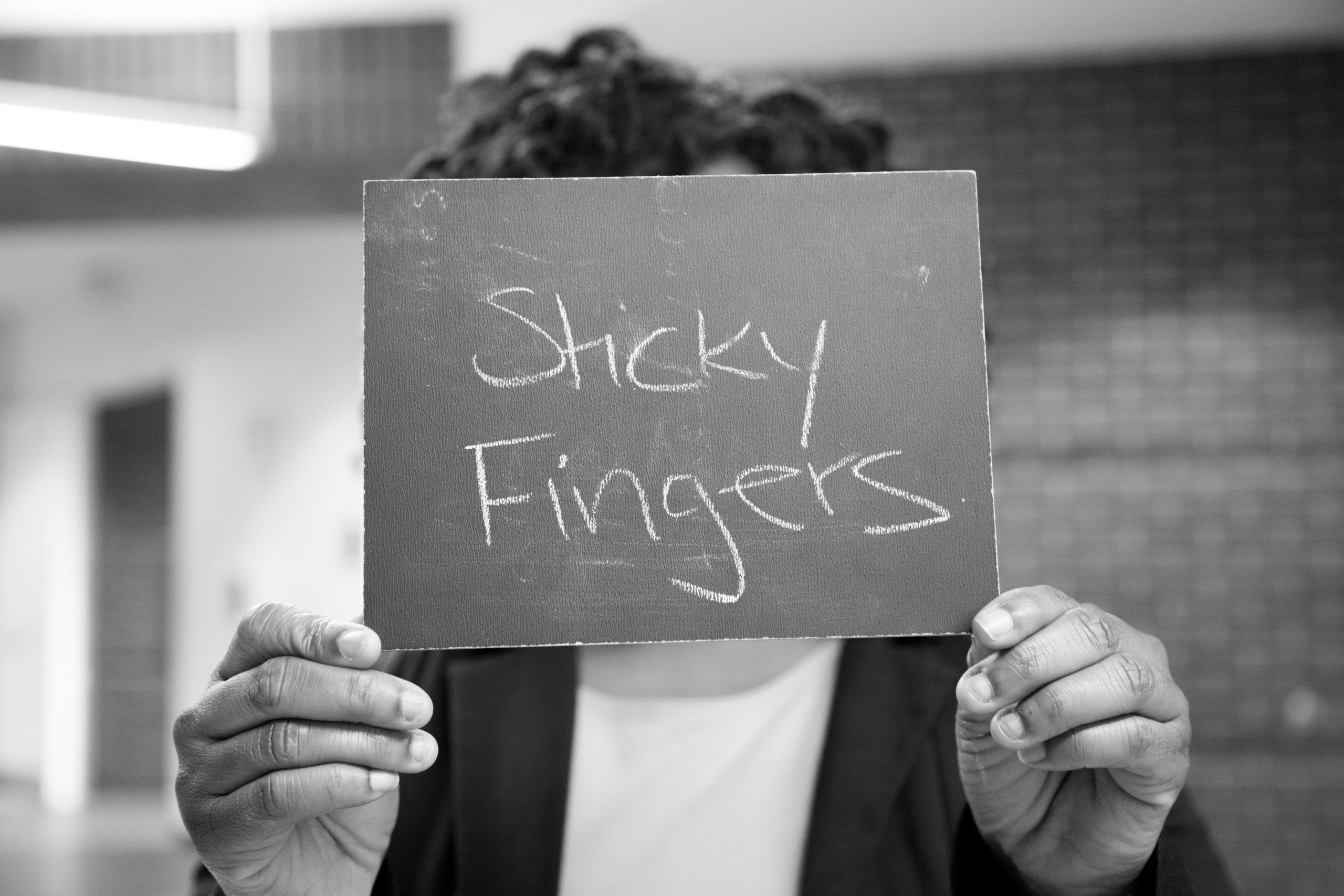 Chalkboard stating Sticky Fingers written in chalk