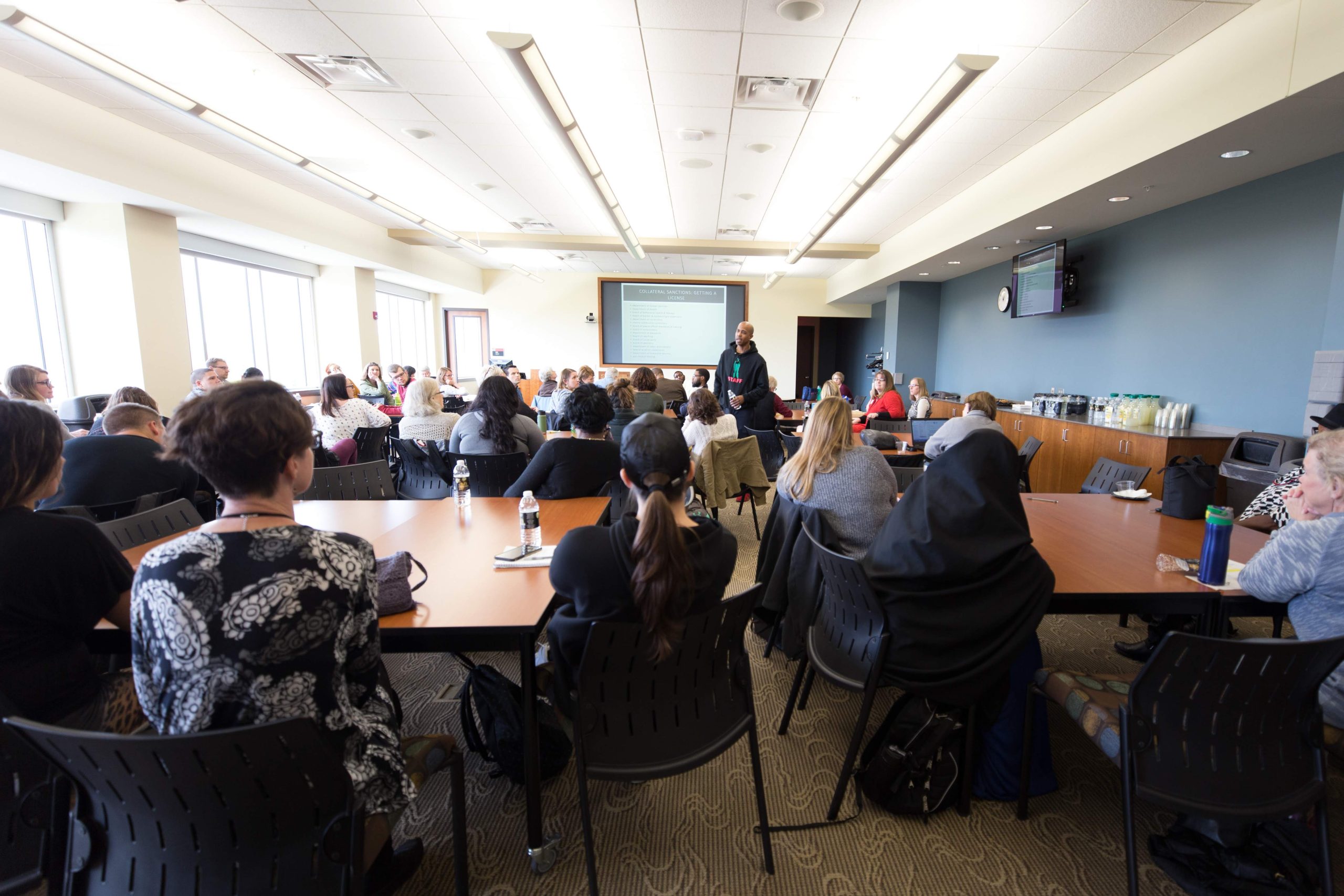Richard speaking to an audience at a college