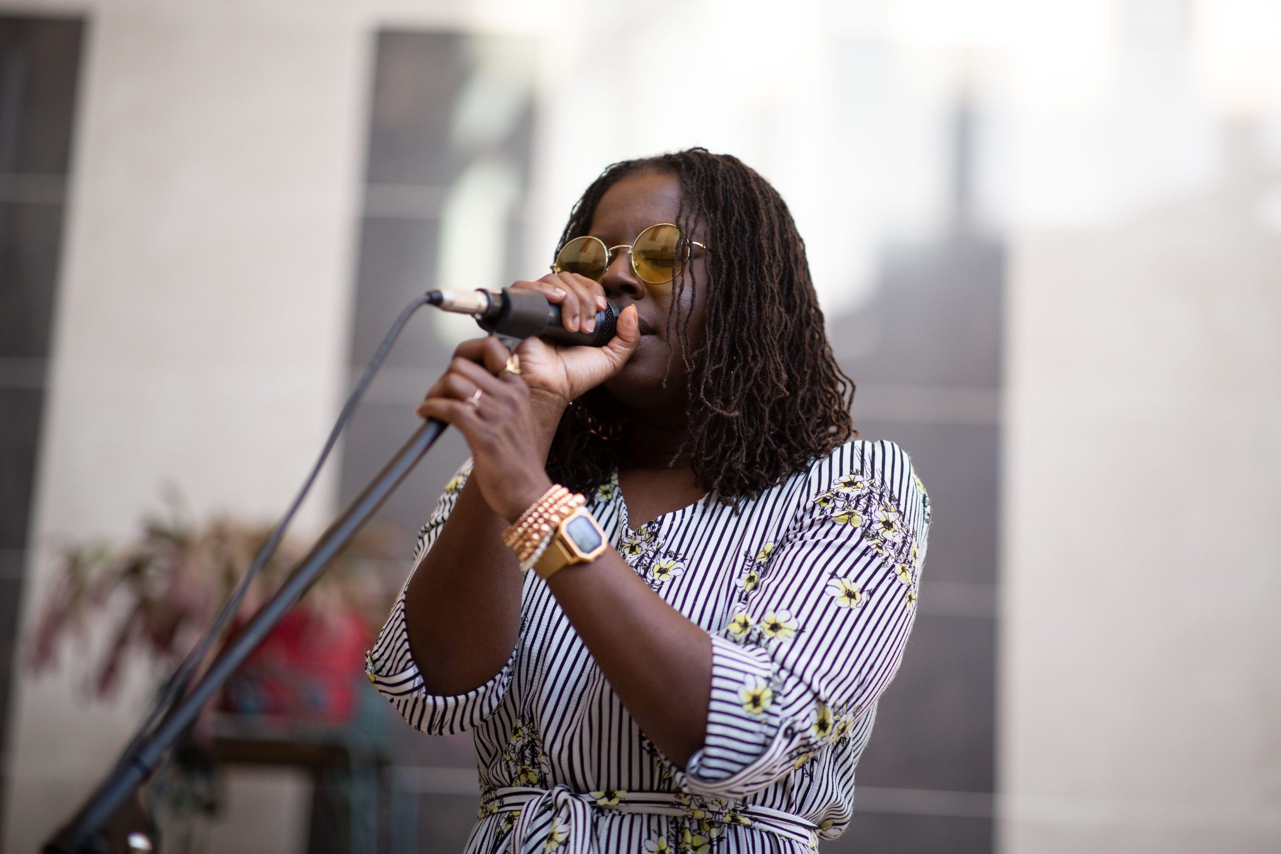 Soteria Shepperson at the OLOV opening, singing into mic