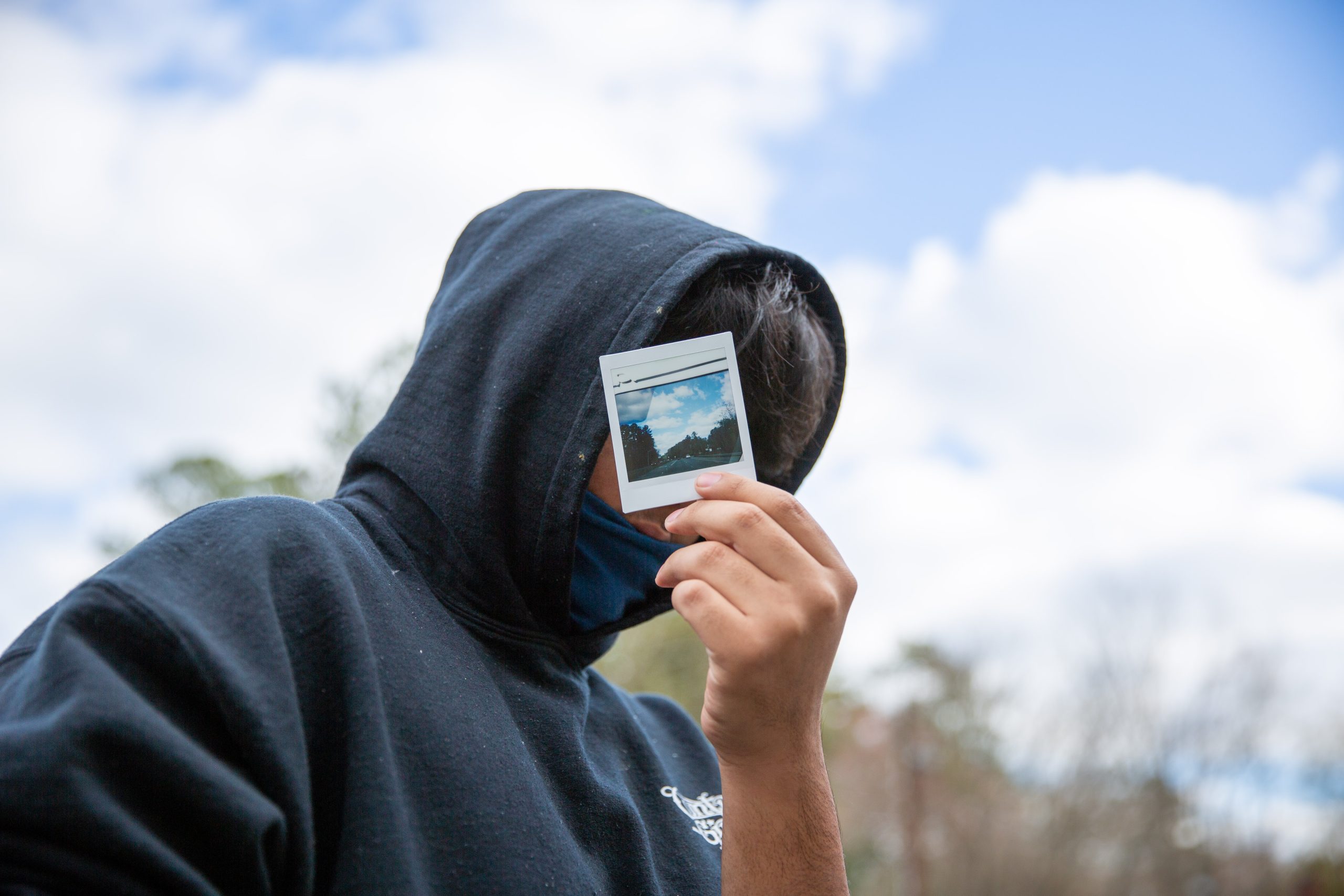 Mother and son in embrace, facing away from the camera