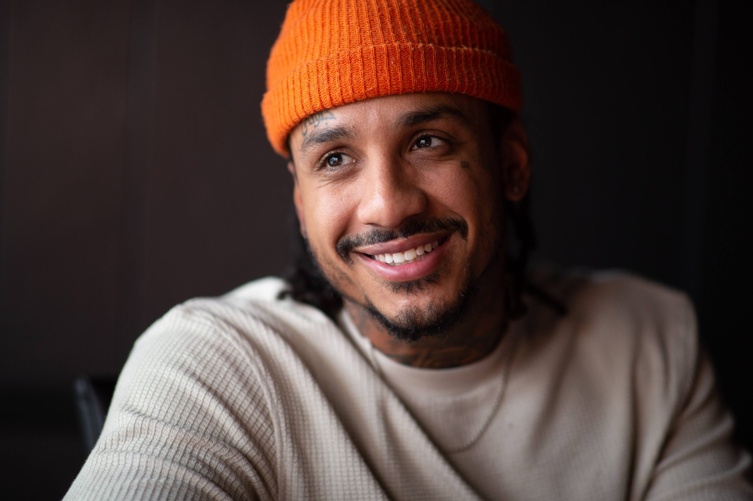 Four canoes in focused foreground, with the outline of a child carrying a pail of lakewater in the background