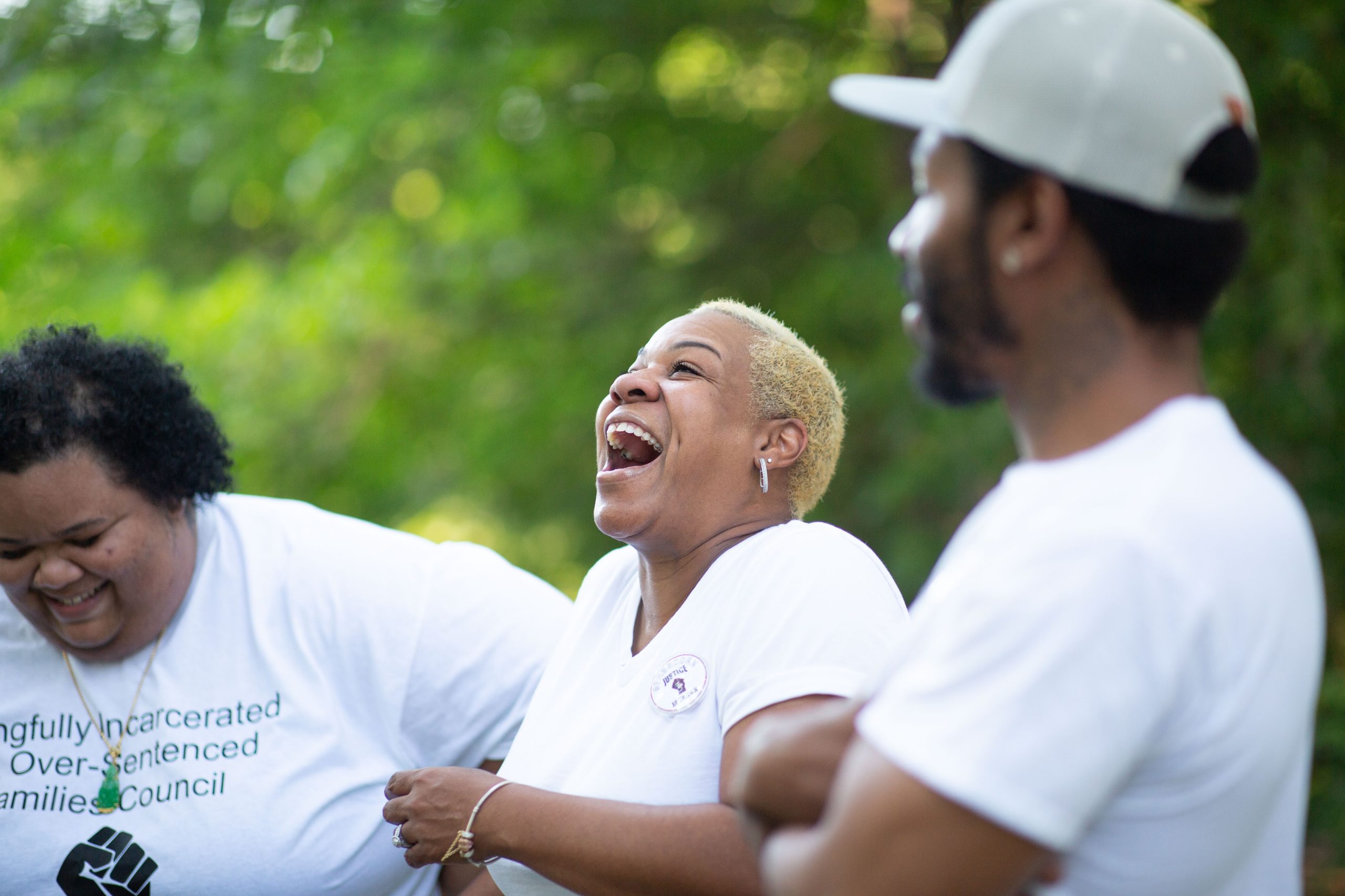 Cornelius' mom laughing with her son and daughter-in-law