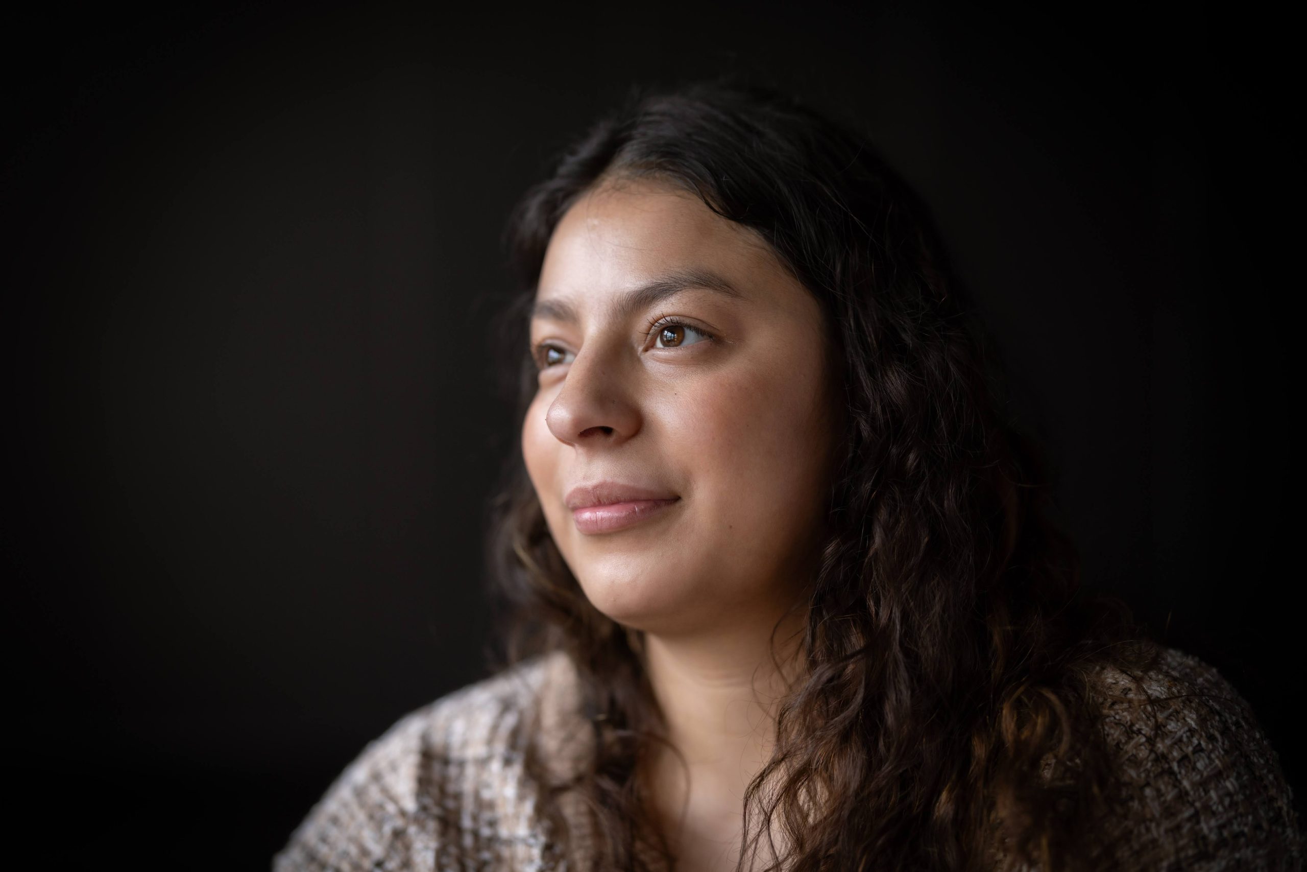 Child in red clothes with a red life vest, holding an oar
