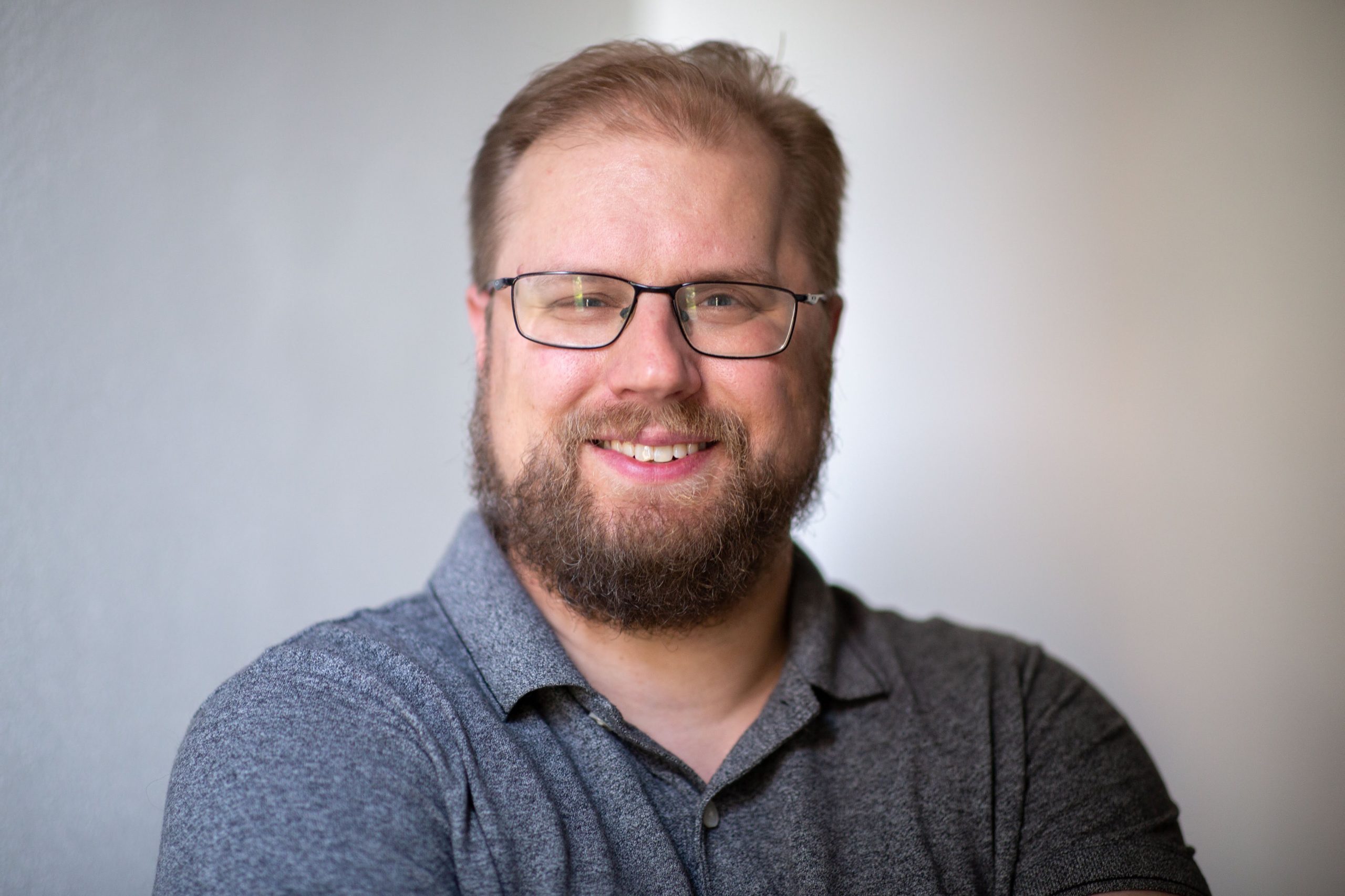 Kahlee and daughter in front of Kahlee's portrait in the Hennepin Theatre Trusts' sidewalk exhibit. She is taking a selfie and looking toward the sun