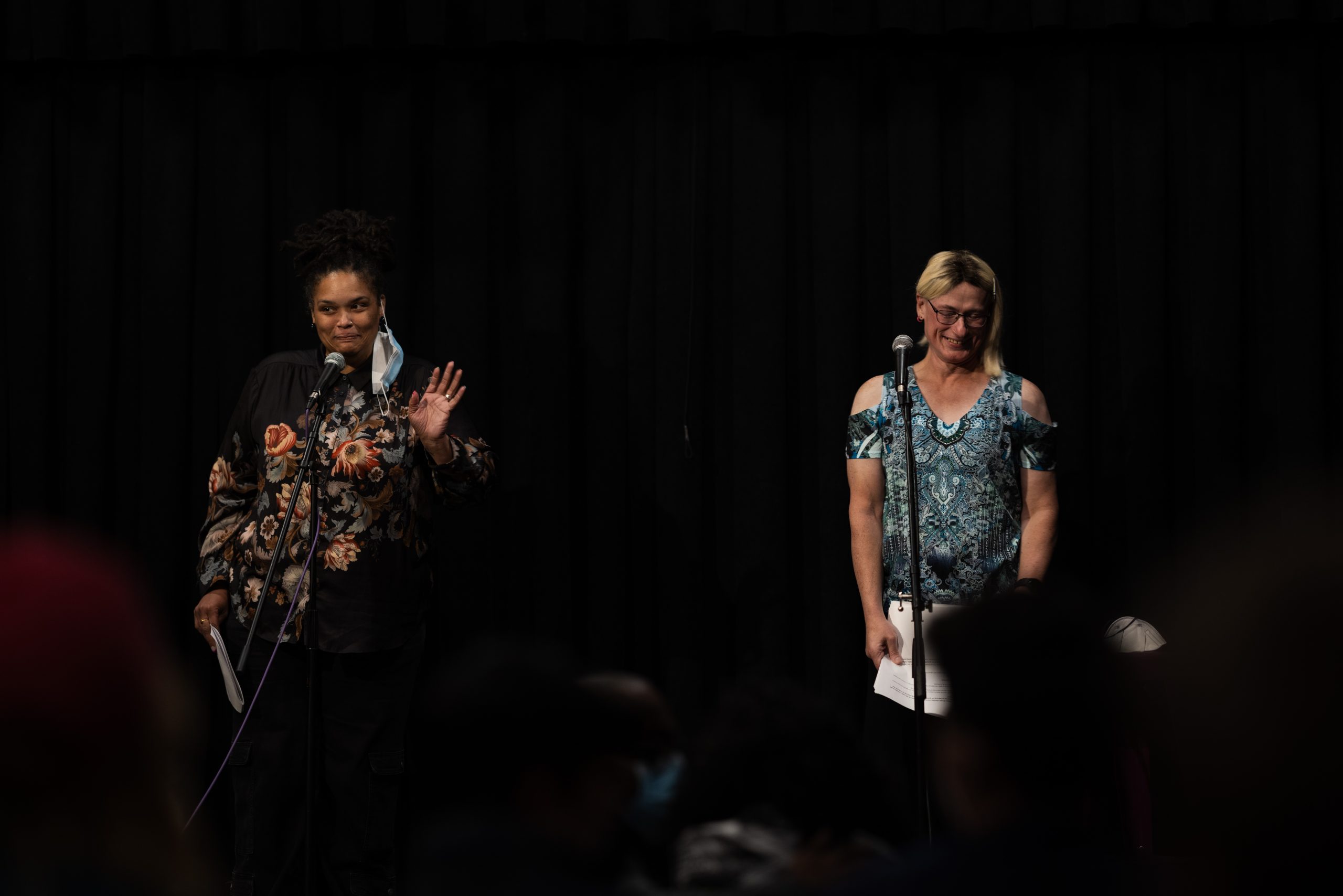 Two people on stage, both smiling