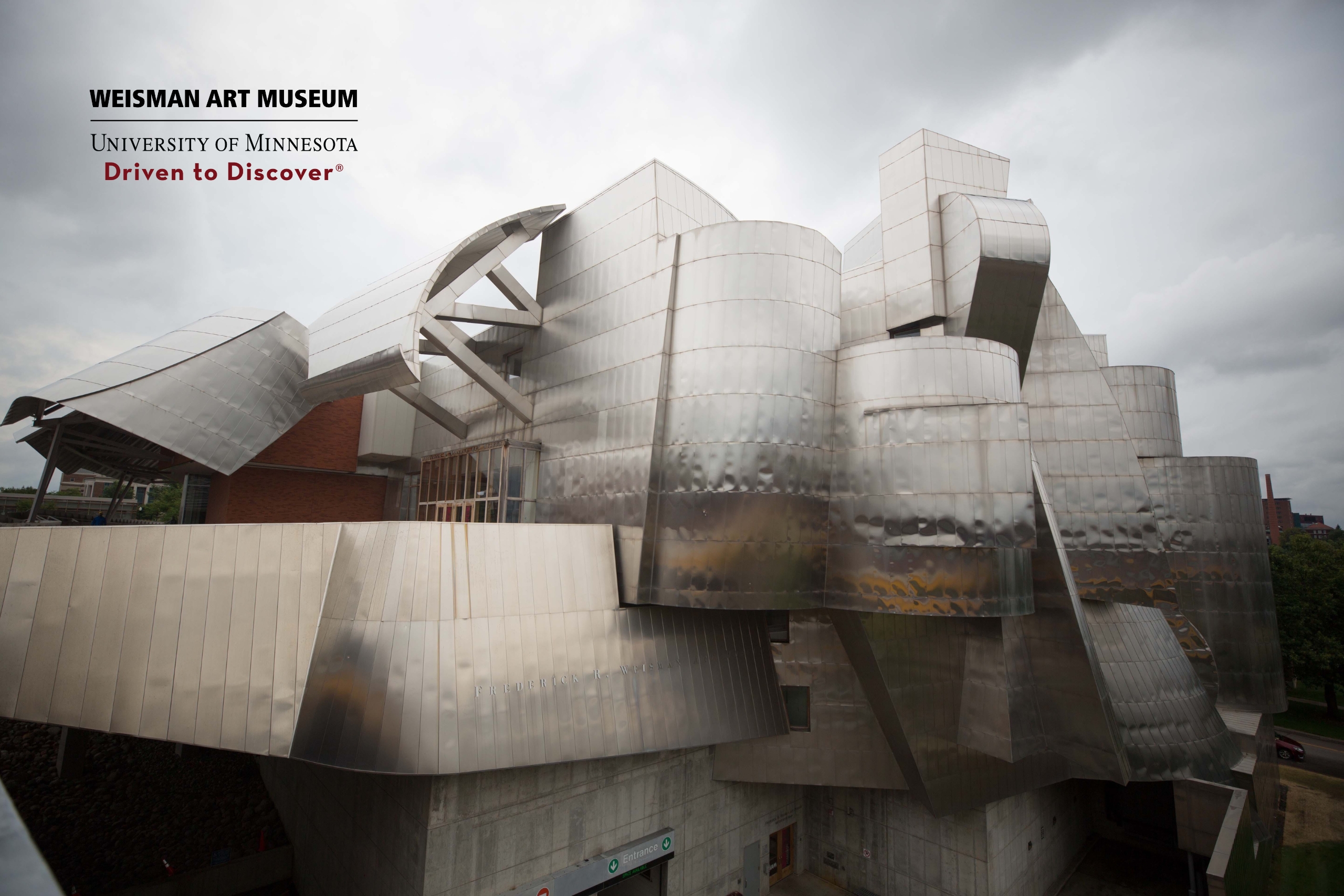 Weisman Art Museum on a cloudy day, logo in upper left corner